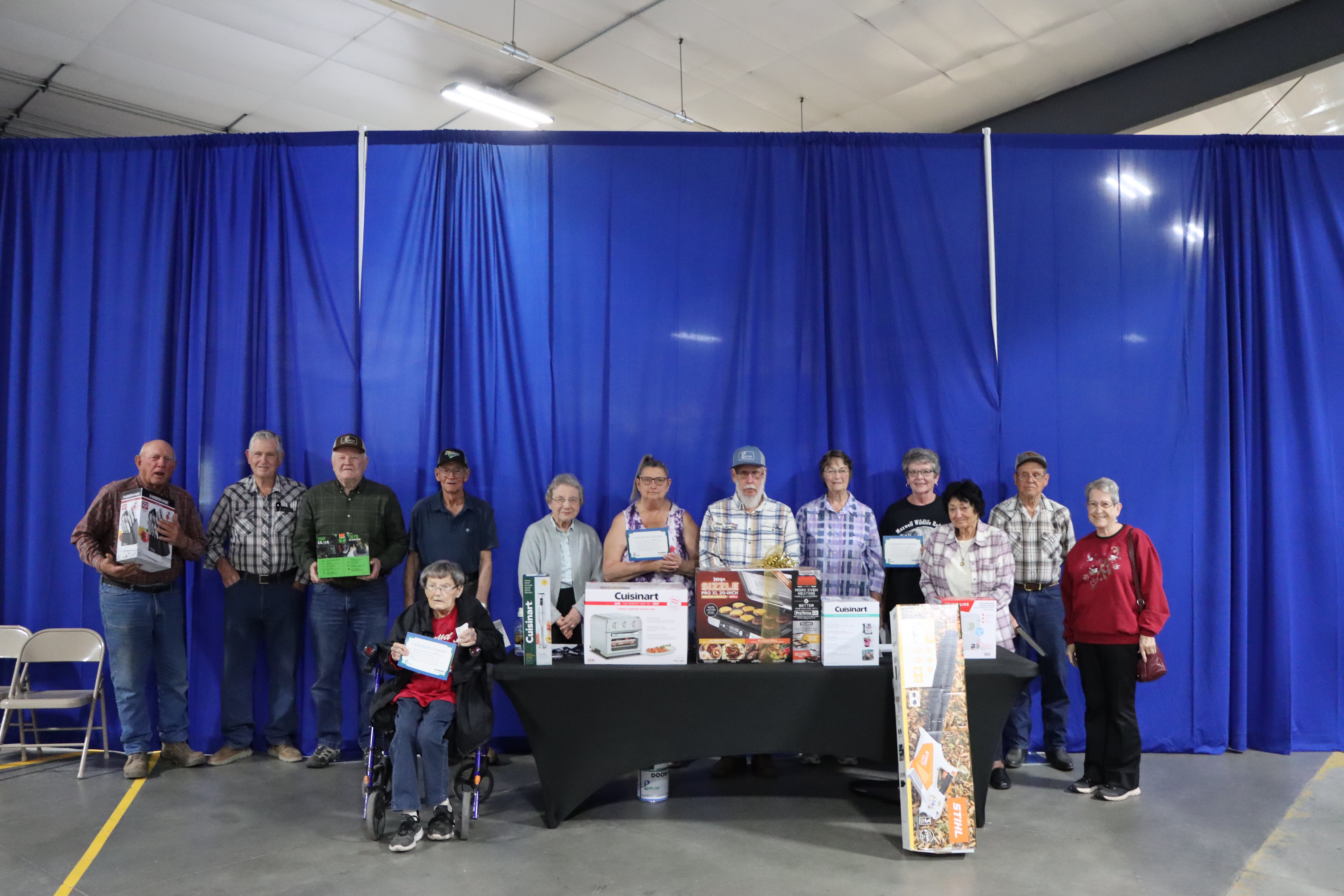 Door prize winners celebrate with their winnings.